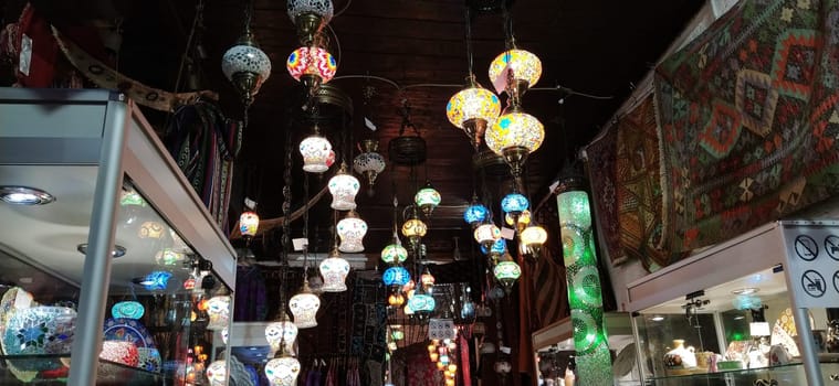 Traditional vintage Turkish lamps over light background in the night. Colored glass lamps and shades on the market in Sarajevo, Bosnia and Herzegovina. Sale of souvenirs in the market