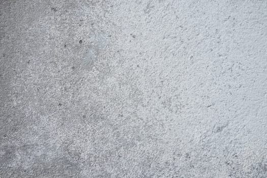 Plastered wall texture. Whitewash surface. Abstract background. Retro wall built structure texture. Cracks and bumps on the concrete wall. Uneven coloring with water-based paint. Old tattered plaster.