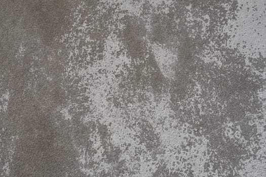 Plastered wall texture. Whitewash surface. Abstract background. Retro wall built structure texture. Cracks and bumps on the concrete wall. Uneven coloring with water-based paint. Old tattered plaster.