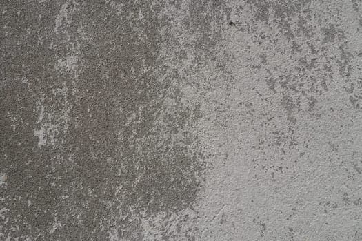 Plastered wall texture. Whitewash surface. Abstract background. Retro wall built structure texture. Cracks and bumps on the concrete wall. Uneven coloring with water-based paint. Old tattered plaster.