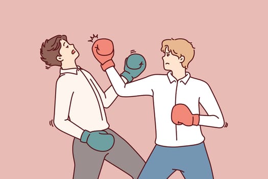 Determined business man in boxing gloves strikes opponent in face, symbolizing fierce competition between employees. Men in business attire are fighting for right to take emerging position of manager