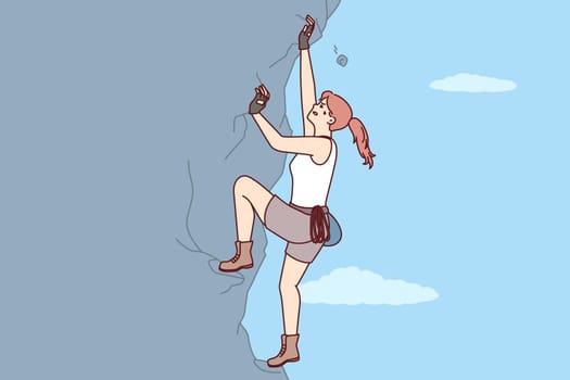 Woman climbs steep cliff to conquer difficult peak without insurance and set new record. Purposeful female rock climber with extreme hobby climbs crag wanting to get new dose of adrenaline