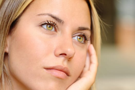 Close up of a distracted woman with beautiful eyes looking away