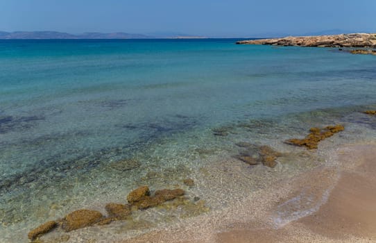 The coast of Aegina island with clear and blue waters of Mediterranean sea in the Saronic gulf, Greece.