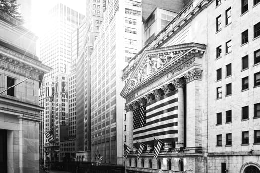 Famous Wall street and the building in New York, New York Stock Exchange with patriot flag