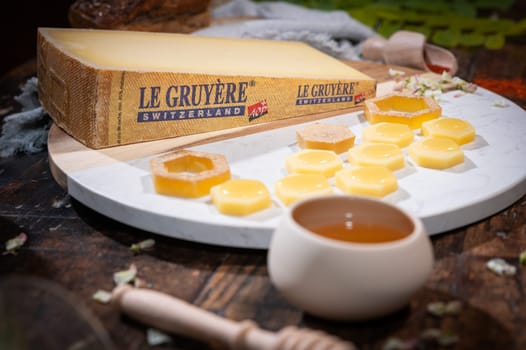 July 12 2022, Lyon, France : Tasted famous swiss cheese : Le Gruyère d'Alpage with honey for lunch and food experience