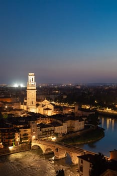 Verona, Italy - June 2022: panorama by night. Illuminated cityscape with scenic bridge