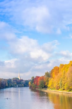 Turin, Piedmont Region, Italy - Circa November 2021: landscape in autumn with Po' river and blue sky.