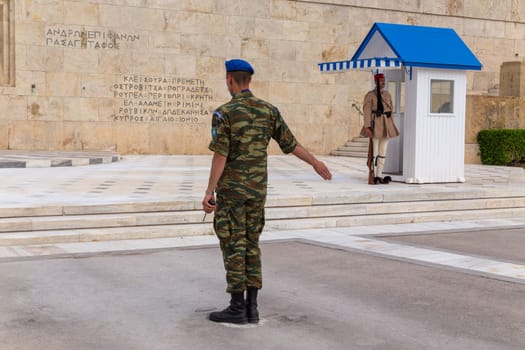 ATHENS, GREECE - MAY 06 2022: Presidential ceremonial guards - Evzones at the Tomb of the Unknown Soldier in front of the Greek Parliament, Athens, Greece