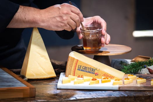 July 12 2022, Lyon, France : Tasted famous swiss cheese : Le Gruyère d'Alpage with honey for lunch and food experience