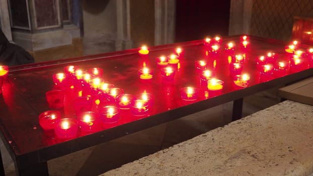 Memorial Day with candle. Commemorative candles are lit. Candle flames burn in the cemetery. Burning candles in the catholic church in Dubrovnik Croatia. Lots of candles. The flame sways in the draft