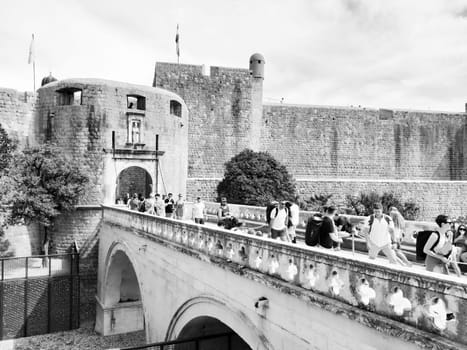 Pile Gate Dubrovnik Croatia August 14 2022 People men and women walk along the stone bridge to the gate of the Old City. Crowd of tourists. Busy entrance. The main entrance to Old Town, busy Pile Gate