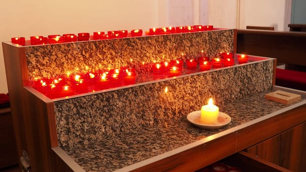 Memorial Day with candle. Commemorative candles are lit. Candle flames burn in the cemetery. Burning candles in the catholic church in Dubrovnik Croatia. Lots of candles. The flame sways in the draft