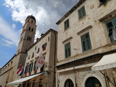 Stradun, Stradone is the main street of the historic city center of Dubrovnik in Croatia. architectural sights. A popular place for tourist walks. August 14, 2022 Tower and facades of ancient houses