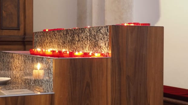 Memorial Day with candle. Commemorative candles are lit. Candle flames burn in the cemetery. Burning candles in the catholic church in Dubrovnik Croatia. Lots of candles. The flame sways in the draft