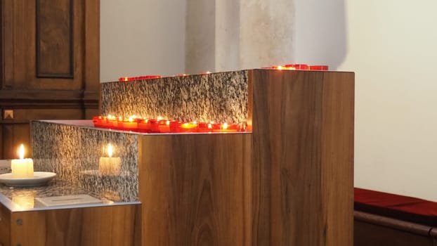 Memorial Day with candle. Commemorative candles are lit. Candle flames burn in the cemetery. Burning candles in the catholic church in Dubrovnik Croatia. Lots of candles. The flame sways in the draft