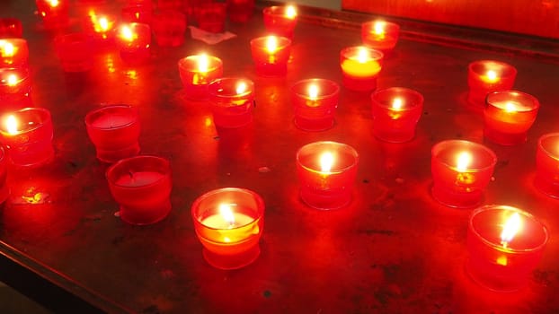 Memorial Day with candle. Commemorative candles are lit. Candle flames burn in the cemetery. Burning candles in the catholic church in Dubrovnik Croatia. Lots of candles. The flame sways in the draft
