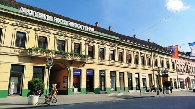 Novi Sad, Serbia 30 April 2022 Hotel Vojvodina is the oldest hotel in the center of the city. European tourism facility. Street with passers-by. Freedom Square. Hotel with rooms provision of services.