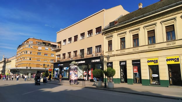 Novi Sad, Serbia 30 April 2022 Hotel Vojvodina is the oldest hotel in the center of the city. European tourism facility. Street with passers-by. Freedom Square. Hotel with rooms provision of services.