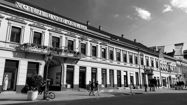 Novi Sad, Serbia 30 April 2022 Hotel Vojvodina is the oldest hotel in the center of the city. European tourism facility. Street with passers-by. Freedom Square. Hotel with rooms provision of services.
