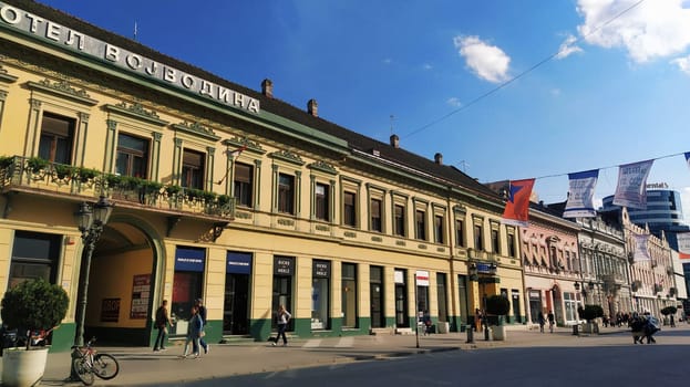 Novi Sad, Serbia 30 April 2022 Hotel Vojvodina is the oldest hotel in the center of the city. European tourism facility. Street with passers-by. Freedom Square. Hotel with rooms provision of services.