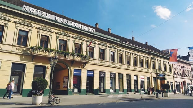 Novi Sad, Serbia 30 April 2022 Hotel Vojvodina is the oldest hotel in the center of the city. European tourism facility. Street with passers-by. Freedom Square. Hotel with rooms provision of services.