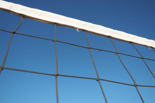 Volleyball sports dividing net against the blue sky close-up. Outdoor sports.