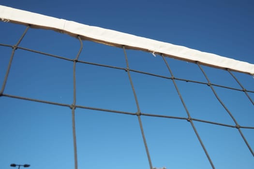 Volleyball sports dividing net against the blue sky close-up. Outdoor sports.