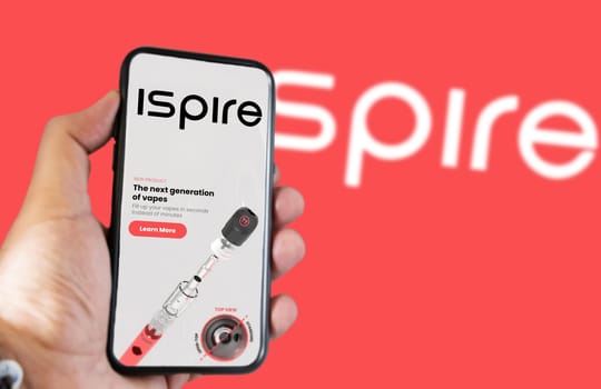 New York, USA, March 2023: Hand holding a phone with Ispire website on the screen. Financial investment and business. Stock market and money. Illustrative editorial