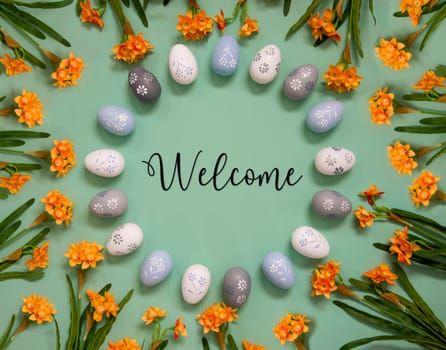Flat Lay With English Text Welcome. Easter Egg Decoration With Orange Spring Flowers. Light Green Paper Background.