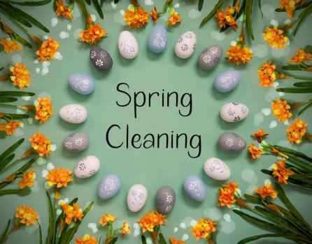 Flat Lay With English Text Spring Cleaning. Easter Egg Decoration With Orange Spring Flowers. Light Green Paper Background With Bright And Shiny Light Effect.