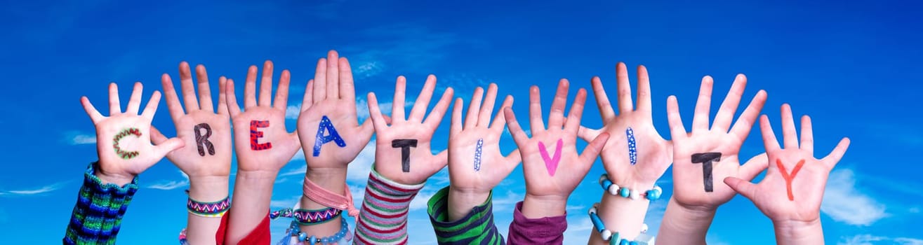 Children Hands Building Colorful English Word Creativity. Blue Sky As Background