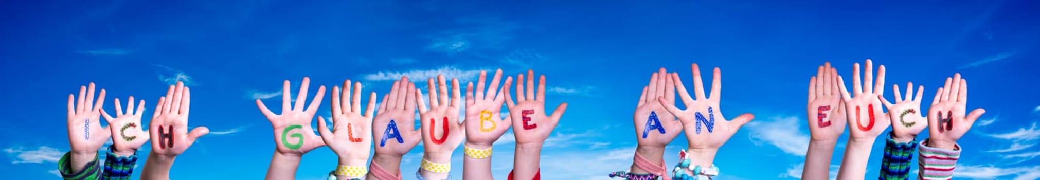 Children Hands Building Colorful German Word Ich Glaube An Euch Means I Believe In You. Blue Sky As Background.