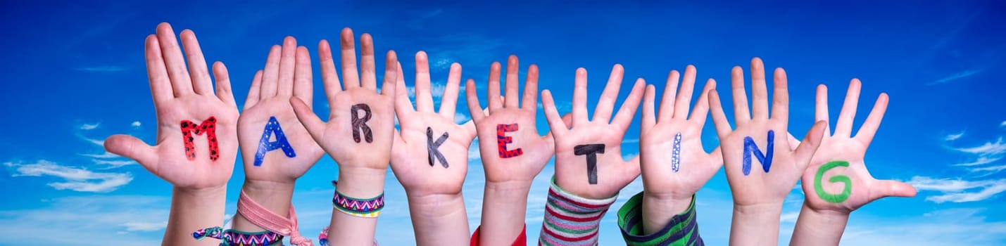 Children Hands Building Colorful English Word Marketing. Blue Sky As Background