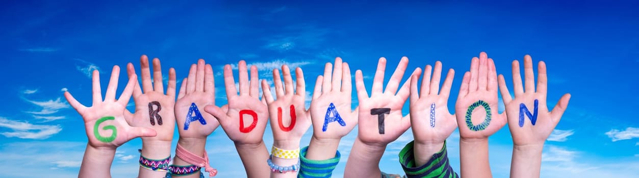 Children Hands Building Colorful English Word Graduation. Blue Sky As Background.