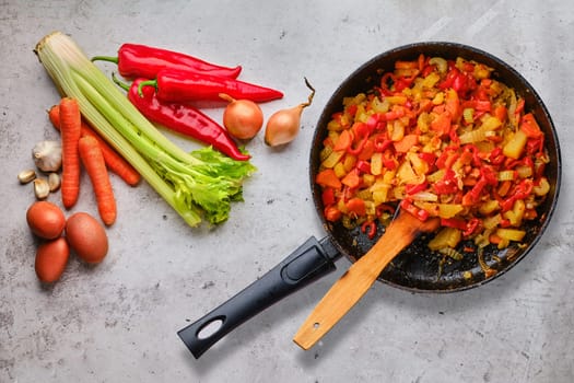 Top view of raw ingredients and ready to eat vegetable ragout
