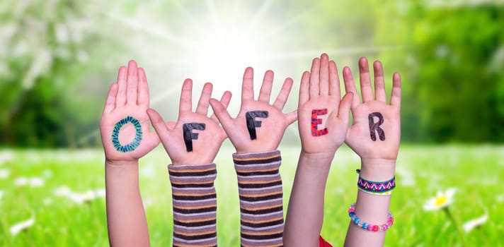 Children Hands Building Colorful English Word Offer. Sunny Green Grass Meadow As Background.