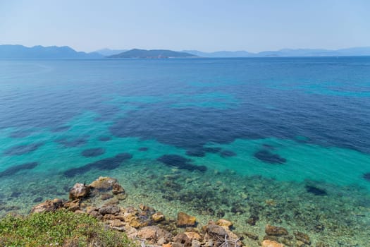 The coast of Aegina island with clear and blue waters of Mediterranean sea in the Saronic gulf, Greece.