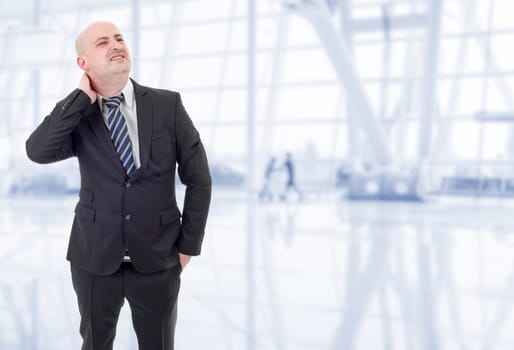 Young businessman with strong back pain, at the office