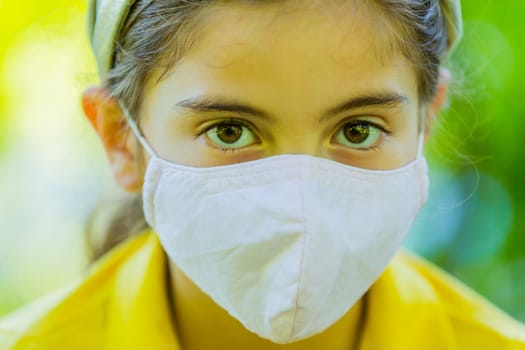 Little girl with mask against corona virus covid outdoor