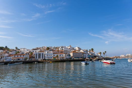 Ferragudo, Portugal - August 25, 2022 - View of the white town with boats moored in the foreground, Ferragudo, Algarve, Portugal, Europe