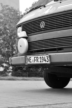 Grayscale shot of VW T3 Bulli ice cream van with a bell in the Media Harbor in Dusseldorf, Germany.
