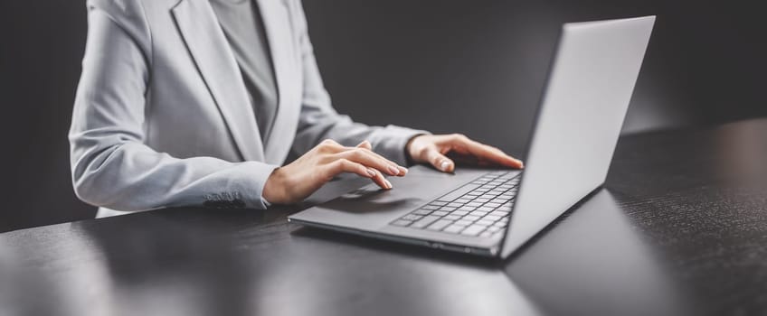Woman with her laptop in the office and working. Concept of the workplace and business.