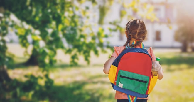 Girl going to study in primary school. Concept of back to school.
