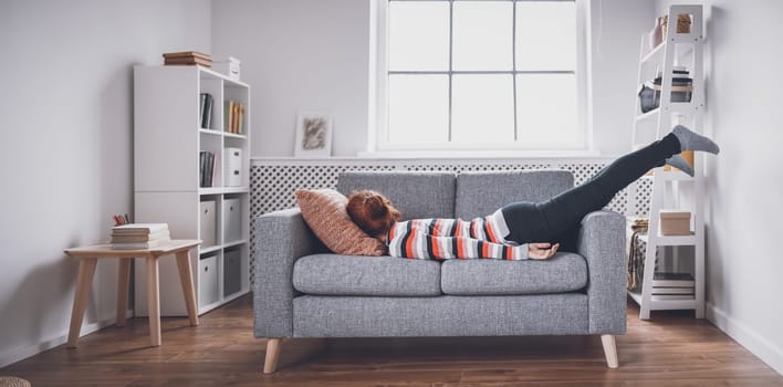 Tired woman lying on the sofa after hard day. Concept of boredom, depression and fatigue.