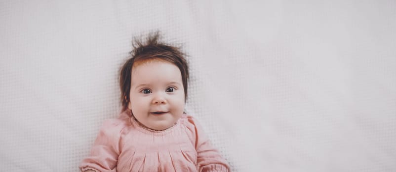 Cute little baby lying on the white blanket. Concept of childhood and new life.