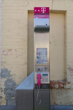 QUEDLINGBURG, GERMANY - JUNE 18, 2021:.Quedlinburg, Germany - June 18, 2021:.Public telephone of the largest German telephone company Telekom, pay phone with a hotspot for Internet access in Quedlinburg