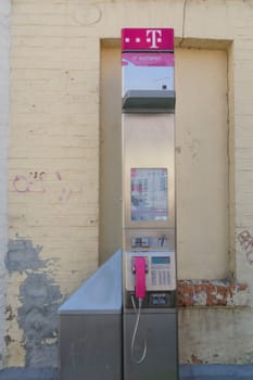 QUEDLINGBURG, GERMANY - JUNE 18, 2021:.Quedlinburg, Germany - June 18, 2021:.Public telephone of the largest German telephone company Telekom, pay phone with a hotspot for Internet access in Quedlinburg