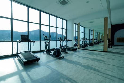 Bayan Lepas, Penang, Malaysia - Nov 16 2021: Group of running machine with shadow from the sun in gym room