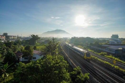 Bukit Mertajam, Penang, Malaysia - Nov 07 2021: Aerial view Malaysia electronic train service (EST) in mosty morning.